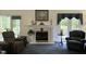 Bright living room showcasing a cozy fireplace and comfortable seating with natural light at 8733 Crowder Rd, Raleigh, NC 27603