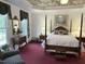 Serene main bedroom with a four-poster bed, floral ceiling, and ample natural light at 8733 Crowder Rd, Raleigh, NC 27603
