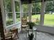 Bright sunroom with large windows offering peaceful views of the landscaped backyard at 8733 Crowder Rd, Raleigh, NC 27603