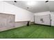 Basement featuring a golf simulation area with artificial turf and white walls at 91 E Walker Woods Ln, Clayton, NC 27527