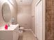 Cozy bathroom features a large oval mirror and a white vanity at 91 E Walker Woods Ln, Clayton, NC 27527