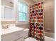 Full bathroom with tub and shower combo, white vanity and a fun patterned shower curtain at 91 E Walker Woods Ln, Clayton, NC 27527