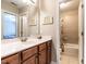 Bathroom featuring a wood vanity with white countertop, a mirror and tub with shower at 91 E Walker Woods Ln, Clayton, NC 27527
