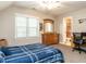 Comfortable bedroom with large window, dresser with mirror and an ensuite bath at 91 E Walker Woods Ln, Clayton, NC 27527