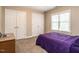 Bedroom featuring carpet, and two closets and a view to the home's exterior at 91 E Walker Woods Ln, Clayton, NC 27527