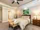 Cozy bedroom with plush carpet, tray ceiling and a doorway to the adjoining bathroom at 91 E Walker Woods Ln, Clayton, NC 27527