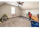 Spacious bonus room with carpet flooring and bright window, perfect for or entertaining at 91 E Walker Woods Ln, Clayton, NC 27527