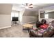 Large bonus room with soft carpet, leather furniture and blue LED strip lighting at 91 E Walker Woods Ln, Clayton, NC 27527