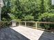 Spacious deck area with wooden floors and a grill, perfect for outdoor cooking and entertaining at 91 E Walker Woods Ln, Clayton, NC 27527