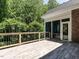 Exterior view of a spacious deck area with a railing and a door to the sunroom at 91 E Walker Woods Ln, Clayton, NC 27527