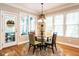 Cozy breakfast nook with a round glass table, four chairs, decorative light fixture and door to outside at 91 E Walker Woods Ln, Clayton, NC 27527