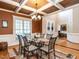 Dining room with coffered ceiling, chandelier, and a decorative area rug creating a cozy ambiance at 91 E Walker Woods Ln, Clayton, NC 27527