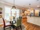Bright breakfast nook area featuring a glass table, four chairs, and a view into the kitchen and backyard at 91 E Walker Woods Ln, Clayton, NC 27527