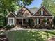 Charming brick home featuring a well-maintained lawn, manicured landscaping, and a welcoming front entrance at 91 E Walker Woods Ln, Clayton, NC 27527