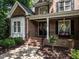 Close up of the brick home's front entrance with well-manicured landscaping and charming details at 91 E Walker Woods Ln, Clayton, NC 27527
