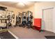Home gym featuring a treadmill, free weights, and weight machines for fitness enthusiasts at 91 E Walker Woods Ln, Clayton, NC 27527