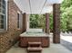 Covered hot tub features brick columns, a two-step entry and a privacy surround at 91 E Walker Woods Ln, Clayton, NC 27527