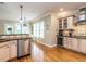 Well-equipped kitchen featuring stone countertops, stainless appliances and a passthrough to a breakfast nook area at 91 E Walker Woods Ln, Clayton, NC 27527