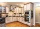 Gourmet kitchen boasts custom cabinets, stainless steel appliances, granite countertops, and a stylish tile backsplash at 91 E Walker Woods Ln, Clayton, NC 27527