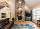 Living room boasts a stone fireplace, vaulted ceilings, and a cozy seating arrangement at 91 E Walker Woods Ln, Clayton, NC 27527