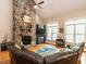 Comfortable living room features vaulted ceilings, stone fireplace, and hardwood floors for a warm atmosphere at 91 E Walker Woods Ln, Clayton, NC 27527