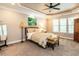 Relaxing main bedroom featuring a tray ceiling, plush carpeting, and large windows for natural light at 91 E Walker Woods Ln, Clayton, NC 27527