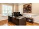 Bright home office with large windows, hardwood floors, and a spacious desk setup at 91 E Walker Woods Ln, Clayton, NC 27527