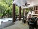 Comfortable covered patio with ceiling fan, brick columns and stylish outdoor furniture at 91 E Walker Woods Ln, Clayton, NC 27527