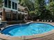 Backyard pool has an elegant stone surround, fountain features, and a brick home at 91 E Walker Woods Ln, Clayton, NC 27527