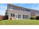 Spacious backyard featuring a well-maintained lawn, vinyl siding, and a walk-out patio area perfect for entertaining at 1005 Fulbright Dr, Morrisville, NC 27560