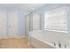 Bathroom featuring soaking tub with a glass shower and window at 1005 Fulbright Dr, Morrisville, NC 27560