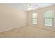 Neutral bedroom with neutral carpet, two windows, and a ceiling fan at 1005 Fulbright Dr, Morrisville, NC 27560