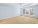 Spacious bedroom with large windows allowing natural light and tray ceiling at 1005 Fulbright Dr, Morrisville, NC 27560