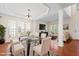 Bright dining room with glass table, hardwood floors, and views to living room and front door at 1005 Fulbright Dr, Morrisville, NC 27560