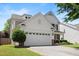 Side view of home highlighting the two-car garage and manicured lawn at 1005 Fulbright Dr, Morrisville, NC 27560