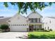 Charming two-story home with a two-car garage and well-manicured front lawn at 1005 Fulbright Dr, Morrisville, NC 27560