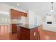 Open floor plan with kitchen island and breakfast bar open to living room with fireplace at 1005 Fulbright Dr, Morrisville, NC 27560