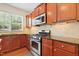 Cozy kitchen featuring stainless steel appliances, granite counters, and tiled backsplash at 1005 Fulbright Dr, Morrisville, NC 27560