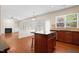 Open kitchen with granite countertops, dark cabinetry, and view to fireplace at 1005 Fulbright Dr, Morrisville, NC 27560