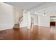 Open-concept living area with hardwood floors, decorative trim, and staircase at 1005 Fulbright Dr, Morrisville, NC 27560