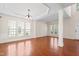 Bright living room with hardwood floors, trim, and large windows offering natural light at 1005 Fulbright Dr, Morrisville, NC 27560