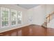 Inviting living room with hardwood floors, a staircase, and ample natural light at 1005 Fulbright Dr, Morrisville, NC 27560