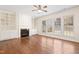 Open-concept living room featuring built-in shelving, a fireplace, and lots of natural light at 1005 Fulbright Dr, Morrisville, NC 27560