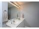 Bright bathroom featuring a double sink vanity, large mirror, and neutral color scheme, perfect for a clean and modern look at 1009 Open Field Dr, Garner, NC 27529