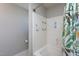 Clean white tiled shower and tub combo with sturdy grab bars and stylish floral shower curtain at 1009 Open Field Dr, Garner, NC 27529