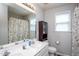 Bathroom featuring dual sinks, a large mirror, a shower with shell curtain, toilet, and vanity at 1009 Open Field Dr, Garner, NC 27529
