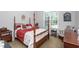 Cozy bedroom with a four post bed, bedside table, and neutral walls at 1009 Open Field Dr, Garner, NC 27529