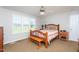 Comfortable bedroom with a wooden bed frame, ceiling fan, and neutral walls at 1009 Open Field Dr, Garner, NC 27529