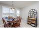Cozy breakfast nook with glass top table, seating for four, and an elegant baker's rack at 1009 Open Field Dr, Garner, NC 27529