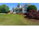 Inviting two-story home features a well-maintained lawn and classic architectural details at 1009 Open Field Dr, Garner, NC 27529